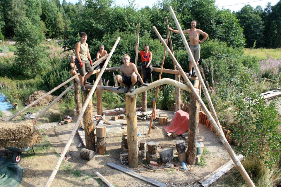 volunteers building the round house structure